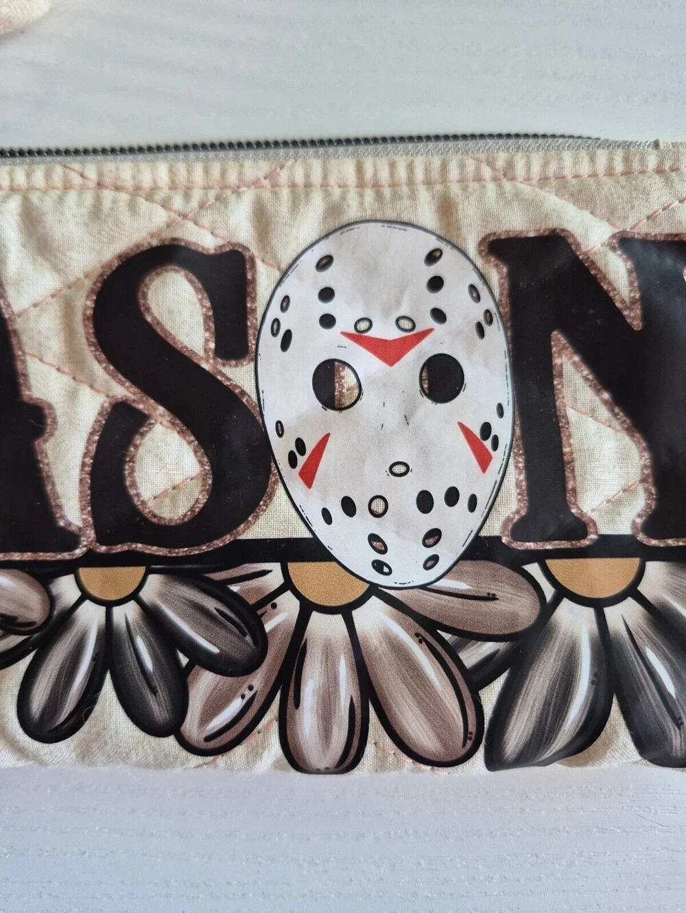 Creme slasher w/ flowers Quilted bow pouch w/ bow zipper pull accent